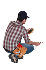 Electrician taking electrical reading