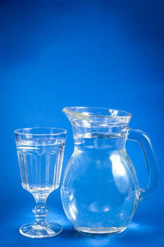 Glass pitcher and glass of water