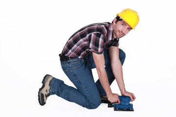 Tradesman using a sander