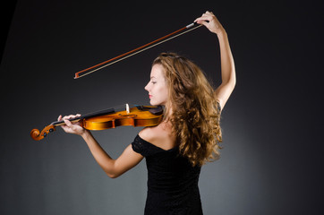 Attractive woman with cello in studio