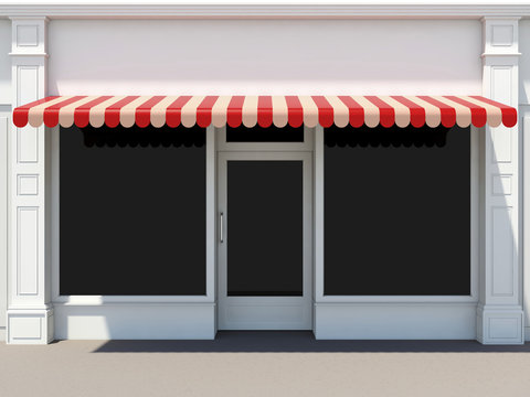 Shopfront in the sun - classic store front with red awnings