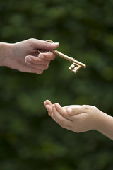 adult hands key to child