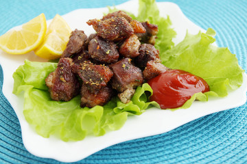 meat with sauce and lemon