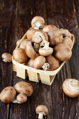 fresh mushrooms,  in a basket on the boards