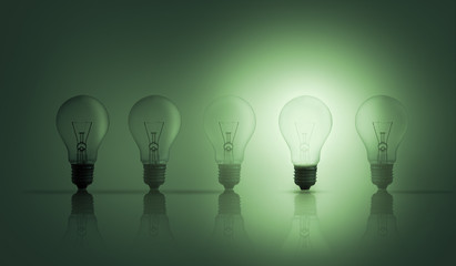 Light bulbs in a row with one lit up