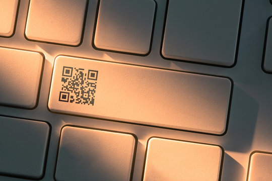 White keyboard with close up on qr code symbol