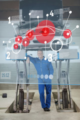 Smiling mechanic standing under futuristic interface