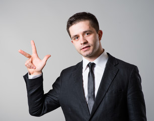  business man showing two fingers or victory gesture