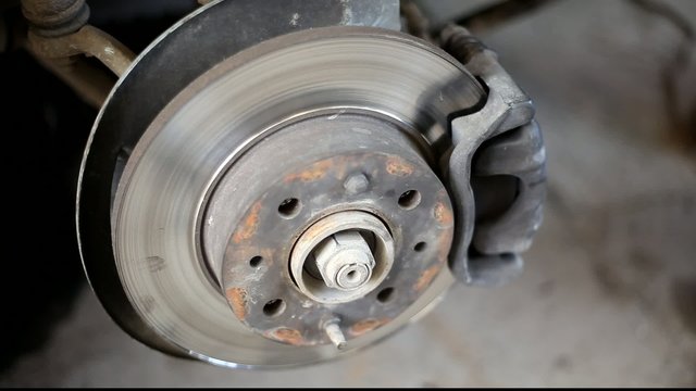 Closeup photo of car disc brakes servicing