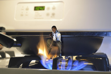 man jumping out of a frying pan and into the fire on a cooker