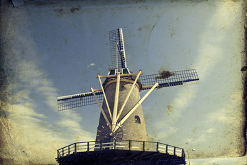 Vintage photo of dutch windmill over blue sky