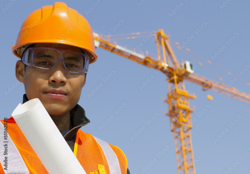 Wall mural close up site manager with safety vest under construction