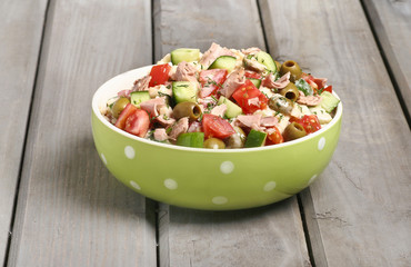 Bowl of vegetable salad on wooden table
