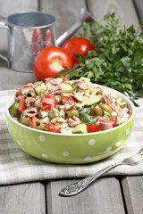 Bowl of vegetable salad on wooden table