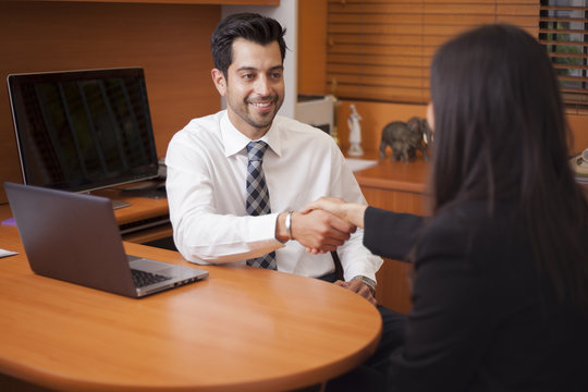 Latin businessman meeting a client in his office