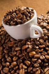 Cup full of black coffee beans