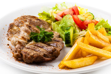 Grilled steak, French fries and vegetables