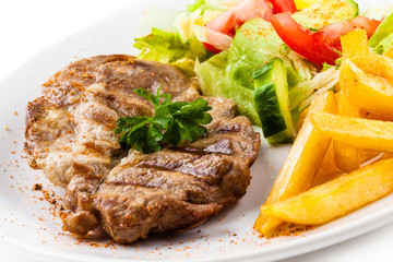 Grilled steak, French fries and vegetables