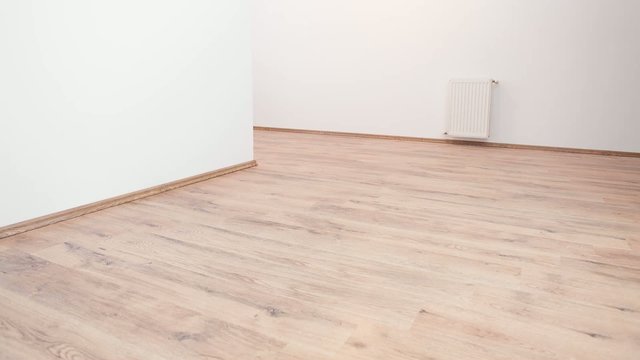 Full HD stop motion video of wood floor tiles getting installed in livingroom