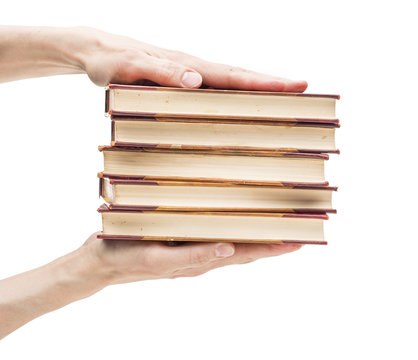 Hands Holding Stack Of Old Books