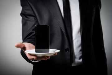 businessman holding a phone in his hand