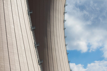 Cooling towesr of  nuclear power plant against sky and clouds
