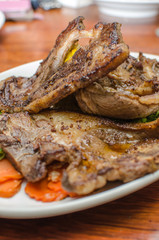Lamb Chop with carrot slices on a white plate