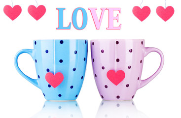 Two cups and tea bags with red heart-shaped label isolated