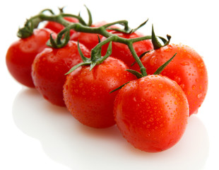 cherry tomatoes on a branch with drops isolated on white