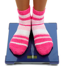 Feet on scales isolated on white