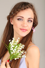 Young woman with beautiful hairstyle and flowers,