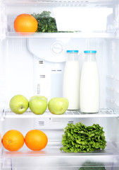 Open refrigerator with vegetarian food