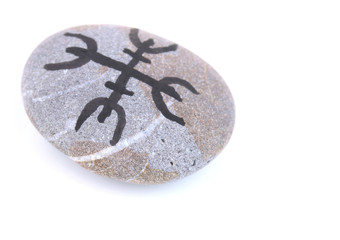 Fortune telling  with symbols on stone isolated on white