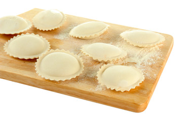 Obraz na płótnie Canvas Raw dumplings on wooden desk, isolated on white