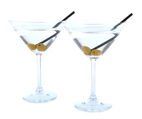 Martini glasses with olives isolated on white.