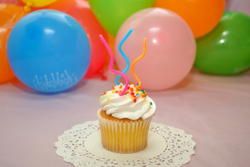 Birthday Cupcake in Front of Balloons