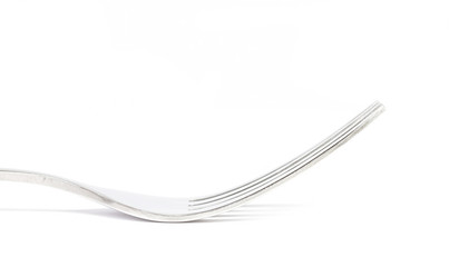 Close up side view of fork on white