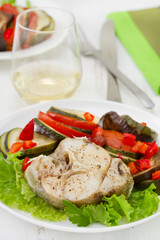 fish with salad and vegetables and glass of white wine