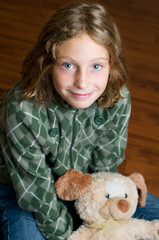 little blue eyed girl with her teddy bear