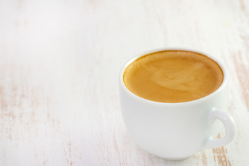 cup of coffee on white wooden table