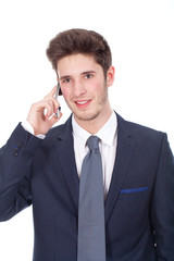 Smiling young executive using cellphone