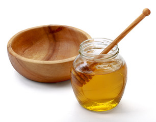 Honey with wood stick , isolated on white background