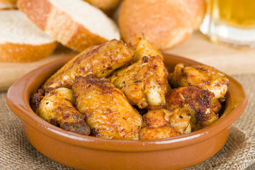 Pollo al Ajillo (Garlic Chicken Wings) with crusty bread & beer.