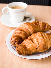 Breakfast with coffee and croissants