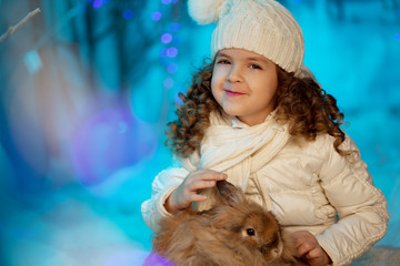 Little winter girl with rabbit