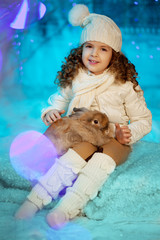 Little winter girl with rabbit