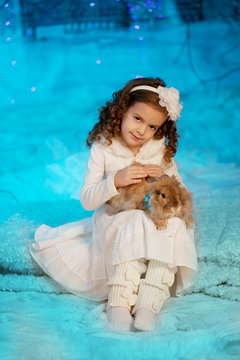 Little winter girl with rabbit