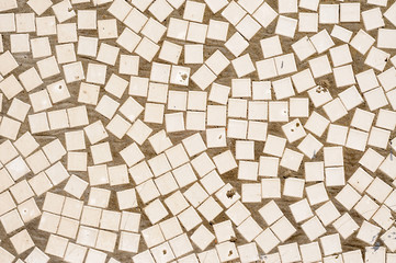 An irregular mosaic texture wall with white tiles