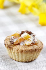 Homemade tarts with dried fruits on checked table cloth