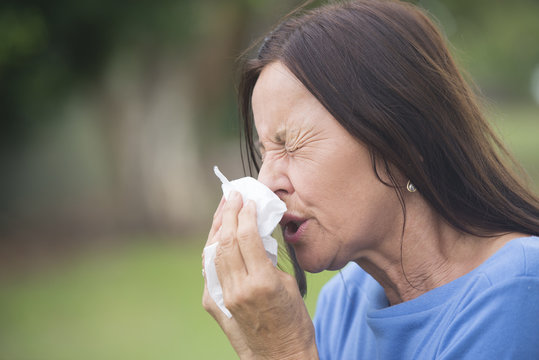 Sick mature woman suffering flu or hayfever